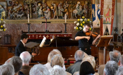 Photo of Sean Riley (violin) and Nathan Tinker (piano), students of the Royal College of Music, performing in the Abbey Church.